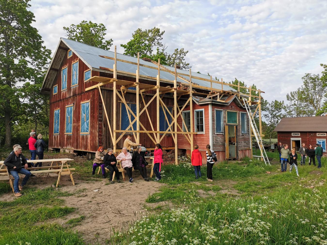 Picture of people around a house